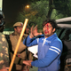 The police detain an injured student outside Jamia Millia Islamia.